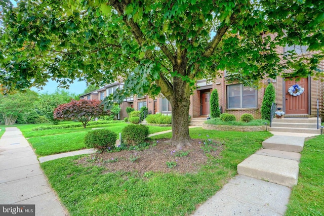 23 Faraday Dr, Lutherville Timonium, MD 21093 - view of property hidden behind natural elements featuring brick siding and a front lawn