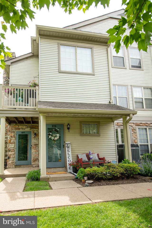 604 Remington Ct, Chalfont, PA 18914 - townhome / multi-family property featuring a balcony, central AC, stone siding, and a porch