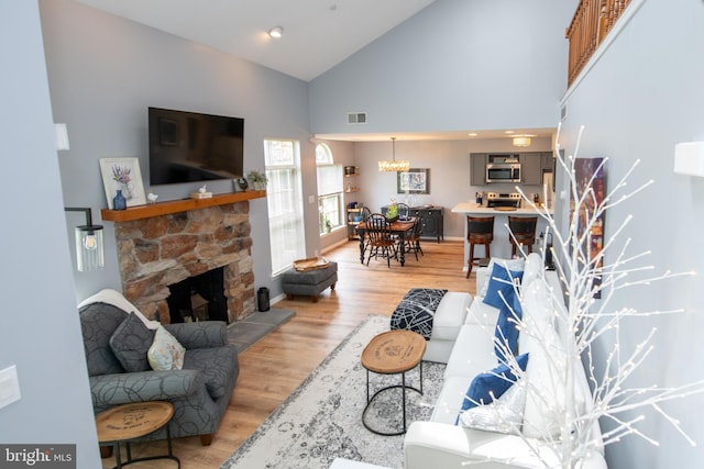604 Remington Ct, Chalfont, PA 18914 - living room with high vaulted ceiling, light wood-style floors, a fireplace, and baseboards