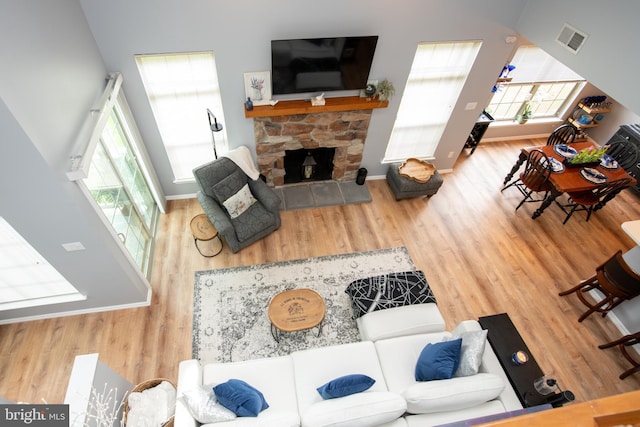 604 Remington Ct, Chalfont, PA 18914 - living area featuring wood finished floors, a stone fireplace, and baseboards