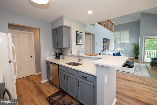 604 Remington Ct, Chalfont, PA 18914 - kitchen with stainless steel dishwasher, a peninsula, gray cabinets, freestanding refrigerator, and a sink