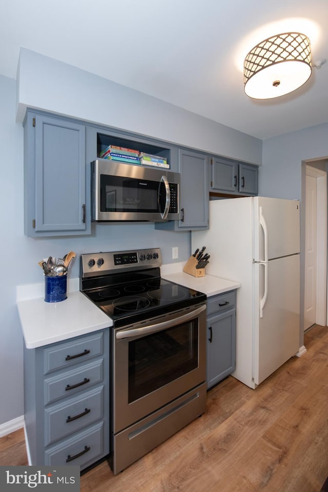 604 Remington Ct, Chalfont, PA 18914 - kitchen featuring appliances with stainless steel finishes, gray cabinetry, light wood-style flooring, and light countertops