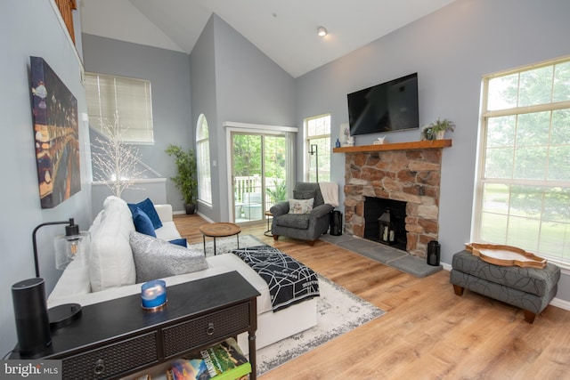 604 Remington Ct, Chalfont, PA 18914 - living area with a stone fireplace, wood finished floors, high vaulted ceiling, and plenty of natural light