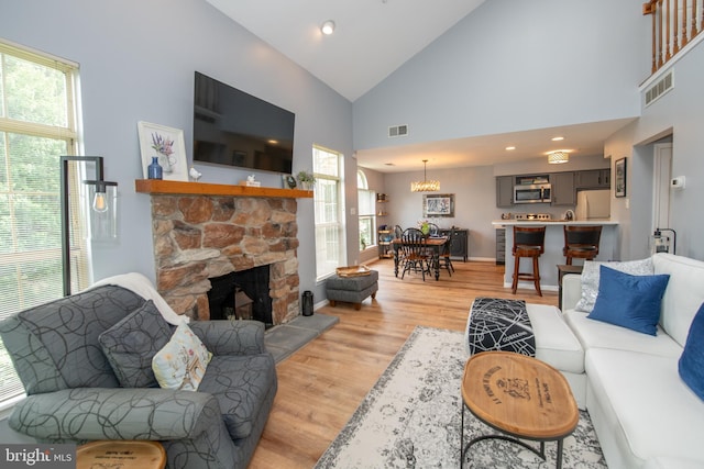 604 Remington Ct, Chalfont, PA 18914 - living area with light wood finished floors, high vaulted ceiling, a stone fireplace, baseboards, and recessed lighting