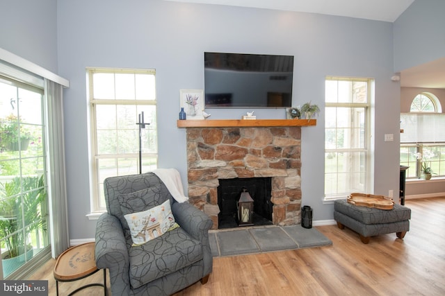604 Remington Ct, Chalfont, PA 18914 - living room featuring wood finished floors, a stone fireplace, and baseboards
