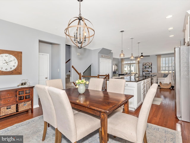 6540 Newton Dr, Frederick, MD 21703 - dining room featuring a chandelier, stairway, wood finished floors, and recessed lighting