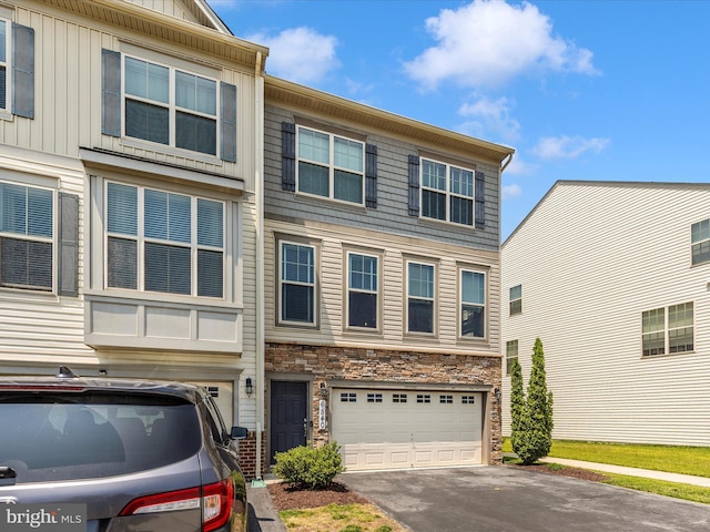 6540 Newton Dr, Frederick, MD 21703 - multi unit property featuring a garage, driveway, stone siding, and board and batten siding
