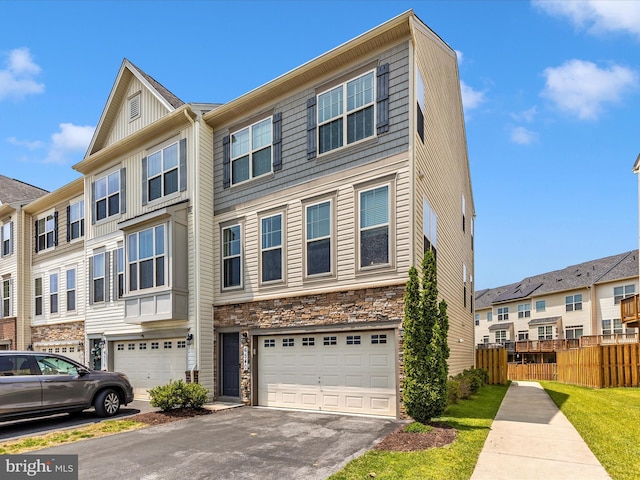 6540 Newton Dr, Frederick, MD 21703 - view of property with stone siding, an attached garage, driveway, and a residential view