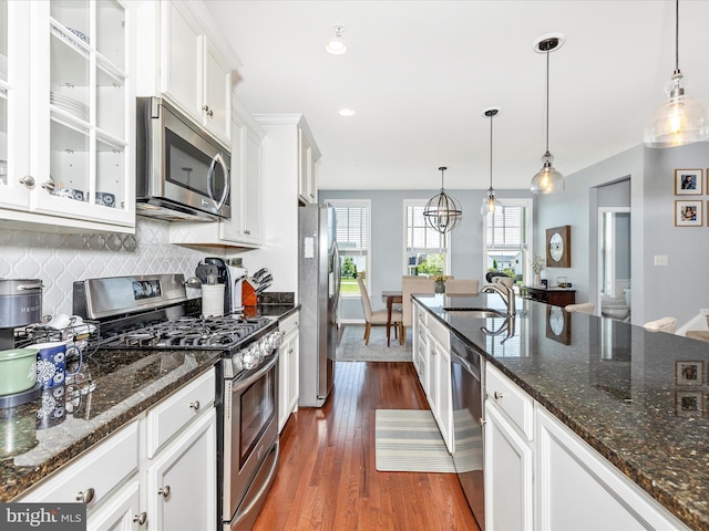 6540 Newton Dr, Frederick, MD 21703 - kitchen featuring stainless steel appliances, a sink, white cabinets, dark wood finished floors, and backsplash