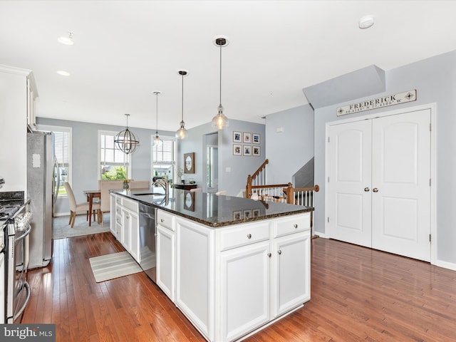 6540 Newton Dr, Frederick, MD 21703 - kitchen featuring a center island with sink, appliances with stainless steel finishes, a sink, dark wood-style flooring, and white cabinetry