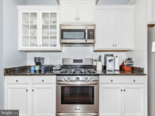 6540 Newton Dr, Frederick, MD 21703 - kitchen featuring stainless steel appliances, white cabinets, glass insert cabinets, and dark stone counters