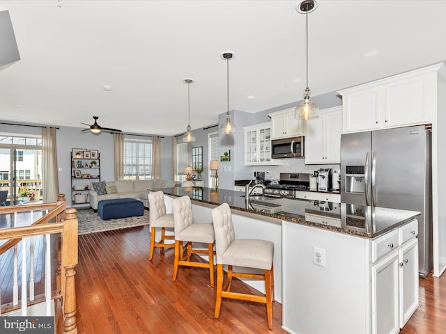 6540 Newton Dr, Frederick, MD 21703 - kitchen with stainless steel appliances, a kitchen bar, a ceiling fan, and healthy amount of natural light