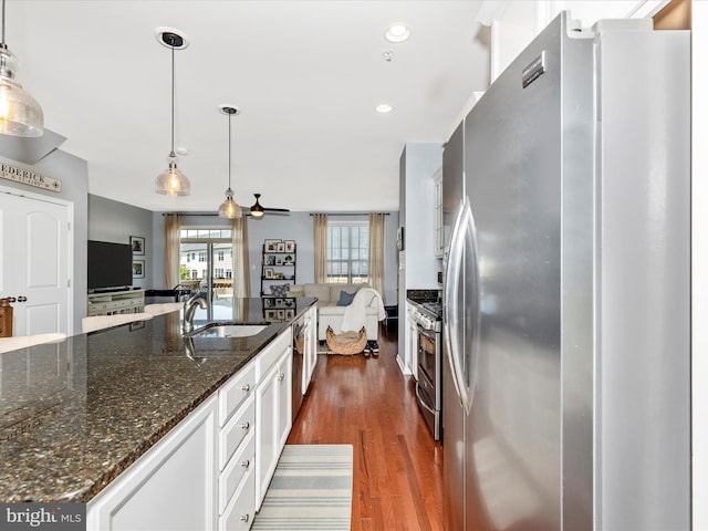 6540 Newton Dr, Frederick, MD 21703 - kitchen featuring stainless steel appliances, a sink, dark wood-type flooring, white cabinetry, and pendant lighting