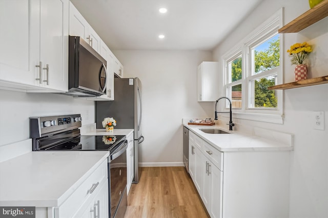 7 Supreme Ct Unit 23-4, Gaithersburg, MD 20878 - kitchen featuring appliances with stainless steel finishes, a sink, open shelves, light wood finished floors, and baseboards