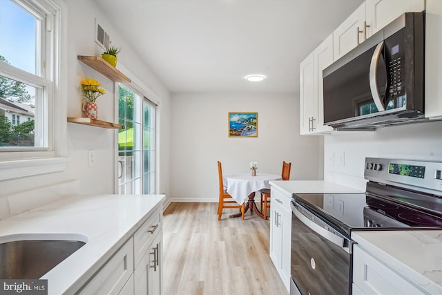 7 Supreme Ct Unit 23-4, Gaithersburg, MD 20878 - kitchen with appliances with stainless steel finishes, light wood finished floors, white cabinetry, light stone counters, and open shelves