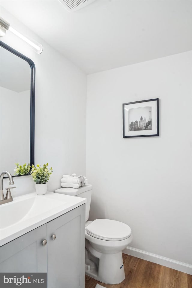 7 Supreme Ct Unit 23-4, Gaithersburg, MD 20878 - bathroom with vanity, wood finished floors, toilet, and baseboards