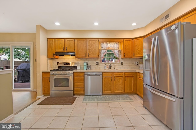 26 Juniper Ave, Somerdale, NJ 08083 - kitchen with appliances with stainless steel finishes, under cabinet range hood, a sink, light countertops, and healthy amount of natural light