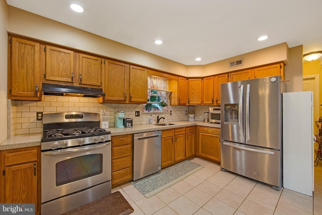 26 Juniper Ave, Somerdale, NJ 08083 - kitchen featuring appliances with stainless steel finishes, under cabinet range hood, a sink, light countertops, and brown cabinets
