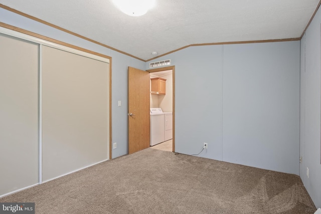 2519 Shureslanding Rd, Darlington, MD 21034 - unfurnished bedroom featuring washing machine and clothes dryer, crown molding, lofted ceiling, carpet, and a closet