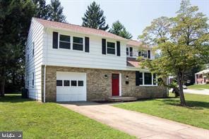 134 W Chestnut Hill Ln, Reisterstown, MD 21136 - view of front of home featuring an attached garage, a front lawn, driveway, and stone siding