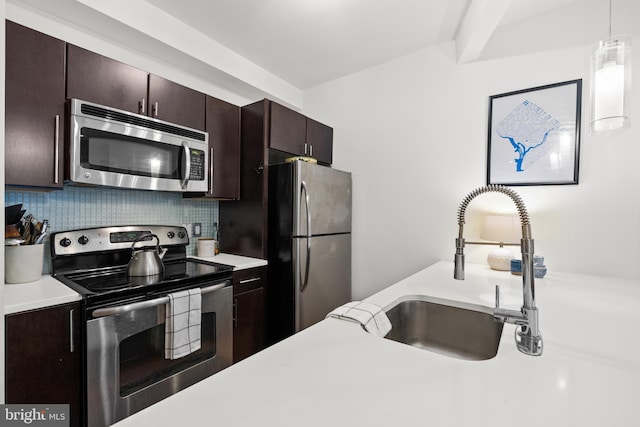 329 Rhode Island Ave NE Unit 104, Washington, DC 20002 - kitchen featuring stainless steel appliances, light countertops, a sink, tasteful backsplash, and dark brown cabinets