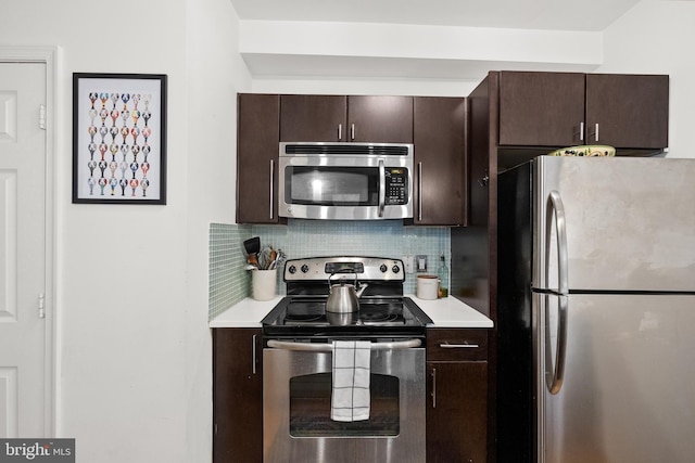 329 Rhode Island Ave NE Unit 104, Washington, DC 20002 - kitchen featuring appliances with stainless steel finishes, light countertops, dark brown cabinetry, and tasteful backsplash