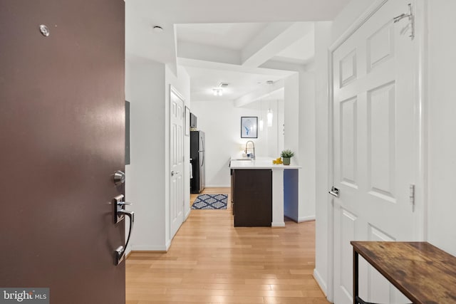 329 Rhode Island Ave NE Unit 104, Washington, DC 20002 - hallway featuring light wood-type flooring, a sink, and baseboards