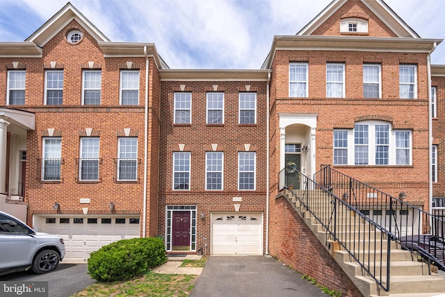 42038 Angel Arch Ter, Aldie, VA 20105 - view of front of property with a garage, brick siding, and asphalt driveway