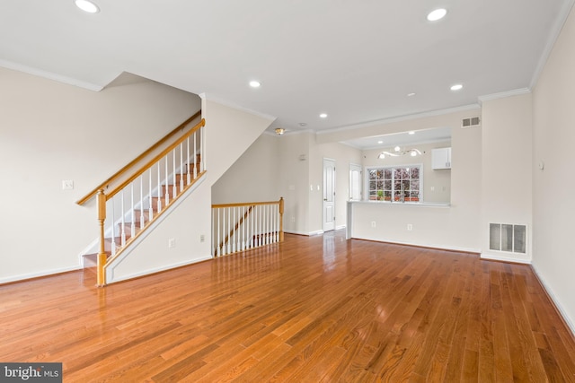 42038 Angel Arch Ter, Aldie, VA 20105 - unfurnished living room with ornamental molding, wood finished floors, recessed lighting, baseboards, and stairway