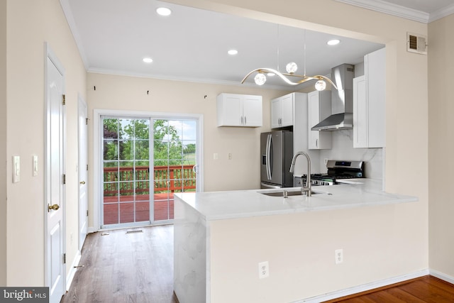 42038 Angel Arch Ter, Aldie, VA 20105 - kitchen featuring wall chimney exhaust hood, appliances with stainless steel finishes, crown molding, light wood-type flooring, and a peninsula