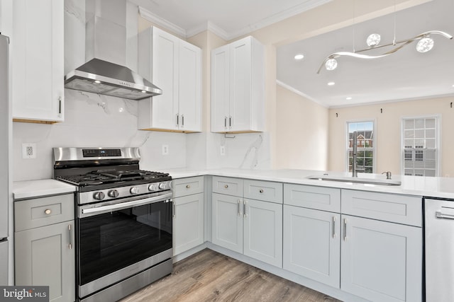 42038 Angel Arch Ter, Aldie, VA 20105 - kitchen with appliances with stainless steel finishes, wall chimney exhaust hood, ornamental molding, light wood-style floors, and light countertops
