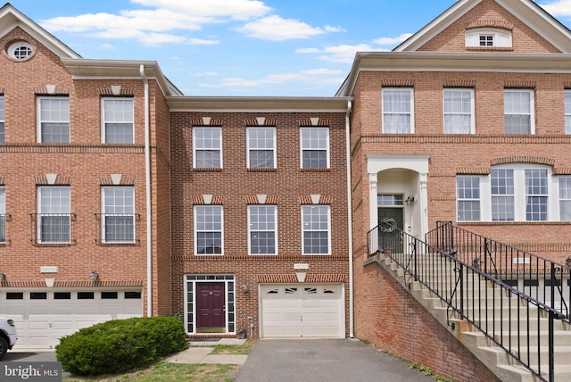 42038 Angel Arch Ter, Aldie, VA 20105 - view of front of property featuring a garage, brick siding, and driveway