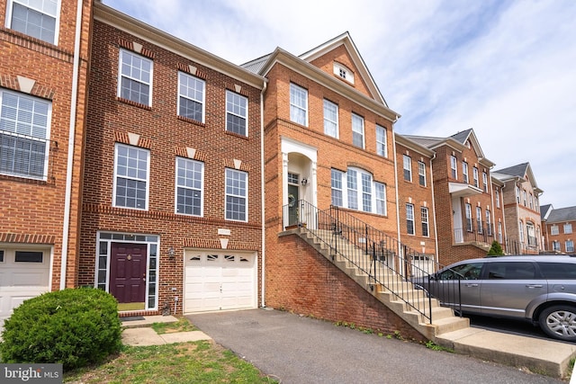 42038 Angel Arch Ter, Aldie, VA 20105 - multi unit property with an attached garage, brick siding, and asphalt driveway