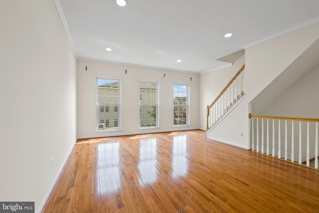 42038 Angel Arch Ter, Aldie, VA 20105 - unfurnished living room featuring crown molding, hardwood / wood-style floors, baseboards, recessed lighting, and stairs