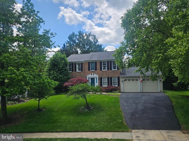 4537 Doncaster Dr, Ellicott City, MD 21043 - colonial house with asphalt driveway, brick siding, a front yard, and an attached garage