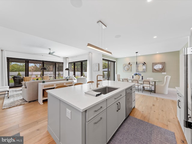 137 Cornwall Rd, Rehoboth Beach, DE 19971 - kitchen featuring a sink, stainless steel dishwasher, a center island with sink, light wood-style floors, and recessed lighting