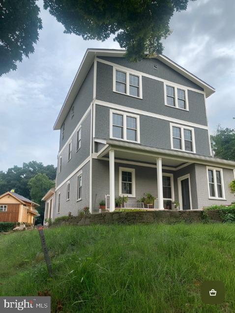 4911 Bayard Blvd, Bethesda, MD 20816 - view of front of house featuring covered porch and brick siding