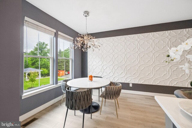 141 Center St S Unit 6, Vienna, VA 22180 - dining room featuring plenty of natural light, baseboards, a chandelier, and light wood finished floors