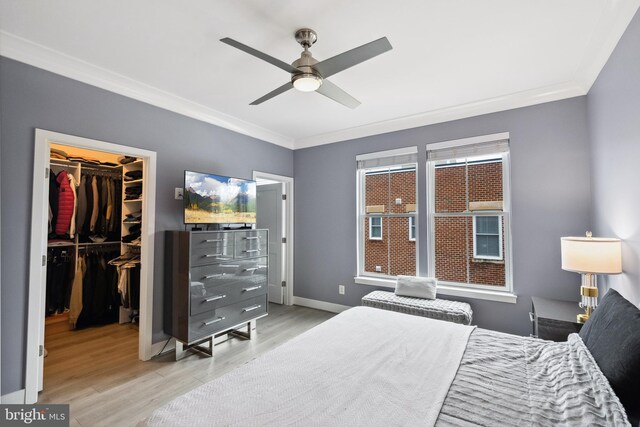 141 Center St S Unit 6, Vienna, VA 22180 - bedroom with crown molding, light wood finished floors, a spacious closet, a closet, and baseboards