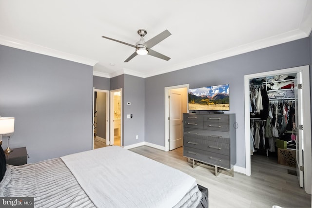 141 Center St S Unit 6, Vienna, VA 22180 - bedroom featuring crown molding, a spacious closet, light wood finished floors, baseboards, and a closet