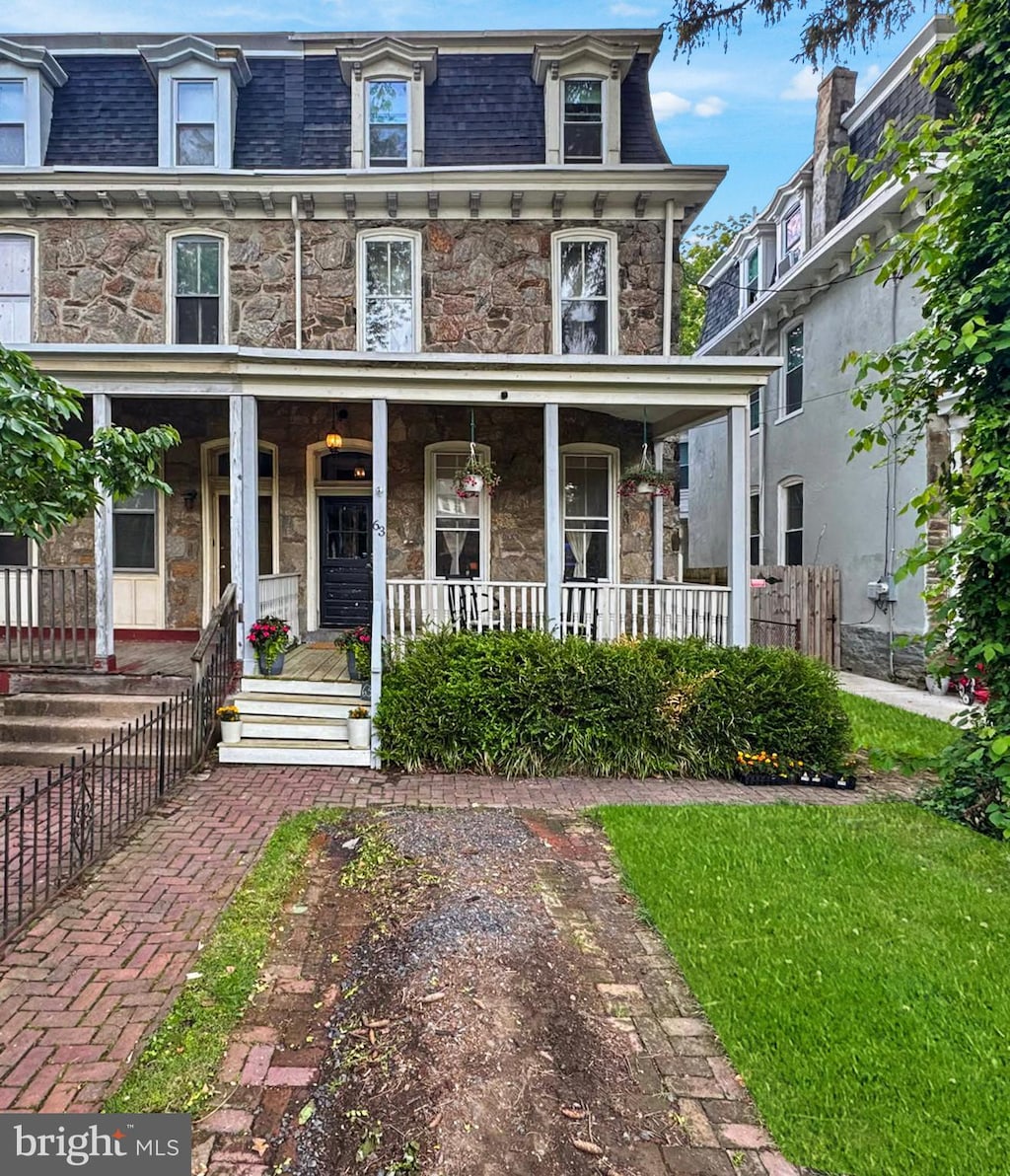 63 W Johnson St, Philadelphia, PA 19144 - second empire-style home with mansard roof, stone siding, and a porch