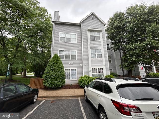 18500 Boysenberry Unit 145-51, Gaithersburg, MD 20879 - view of front facade with uncovered parking and a chimney