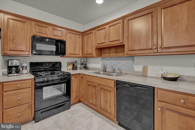 749 Seem Dr, Kutztown, PA 19530 - kitchen featuring black appliances, a sink, light tile patterned floors, light countertops, and brown cabinets