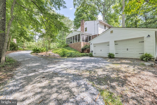 20720 Warfield Ct, Gaithersburg, MD 20882 - view of home's exterior with a sunroom, a chimney, and driveway