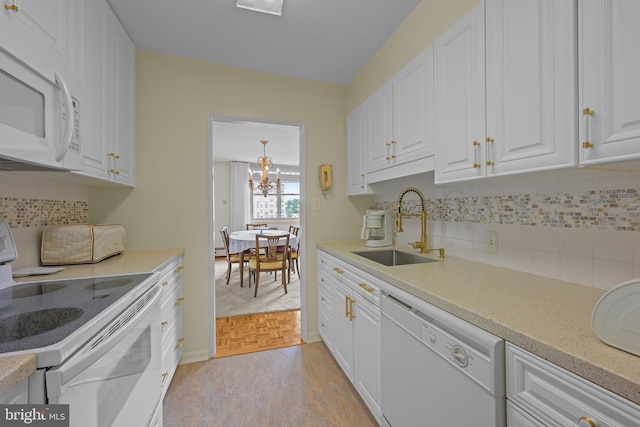 1301 N Harrison St Unit 708, Wilmington, DE 19806 - kitchen with white appliances, white cabinetry, tasteful backsplash, and a chandelier