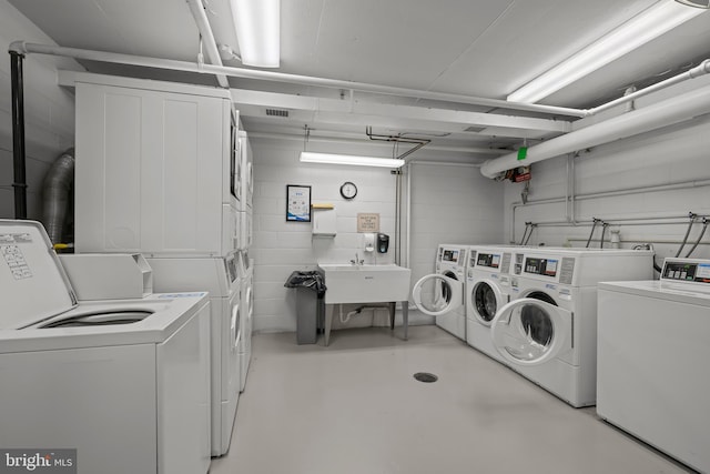 1301 N Harrison St Unit 708, Wilmington, DE 19806 - shared laundry featuring stacked washer and clothes dryer, washing machine and clothes dryer, and concrete block wall