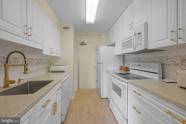 1301 N Harrison St Unit 708, Wilmington, DE 19806 - kitchen with white appliances, white cabinets, decorative backsplash, light wood-style floors, and light stone countertops