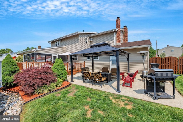 31 Bently Dr, Sewell, NJ 08080 - back of property featuring a gazebo, a chimney, a fire pit, a patio, and a sunroom