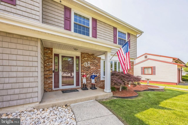 31 Bently Dr, Sewell, NJ 08080 - view of exterior entry featuring covered porch, a yard, and brick siding