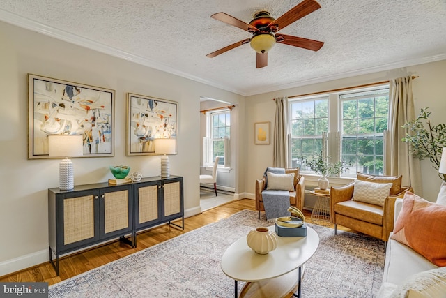 715 S Washington St Unit A-13, Alexandria, VA 22314 - living area featuring crown molding, a ceiling fan, wood finished floors, a textured ceiling, and baseboards